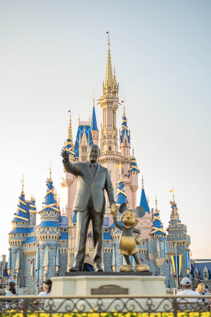 pexels-photo-8183995 Iconic Walt Disney and Mickey Mouse statue in front of Cinderella Castle at Disney World's Magic Kingdom.